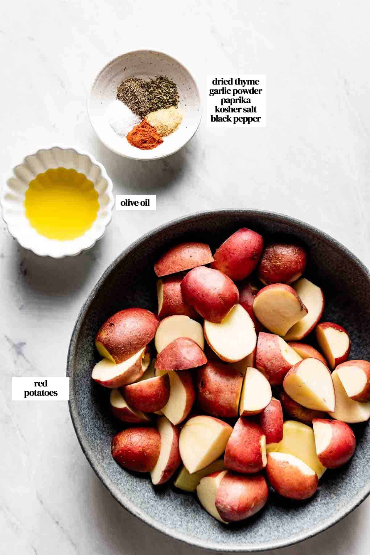 Ingredients needed for cooking red potatoes in air fryer on a marble.