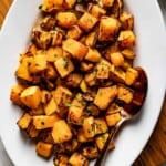 Air fryer roasted butternut squash on a plate from the top view.