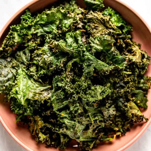 Crispy baked kale leaves in a bowl from the top view.