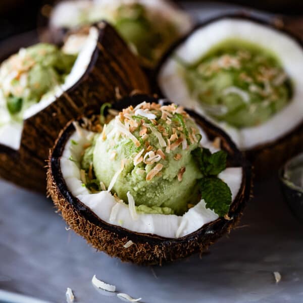 Homemade avocado ice cream placed in a coconut bowl.