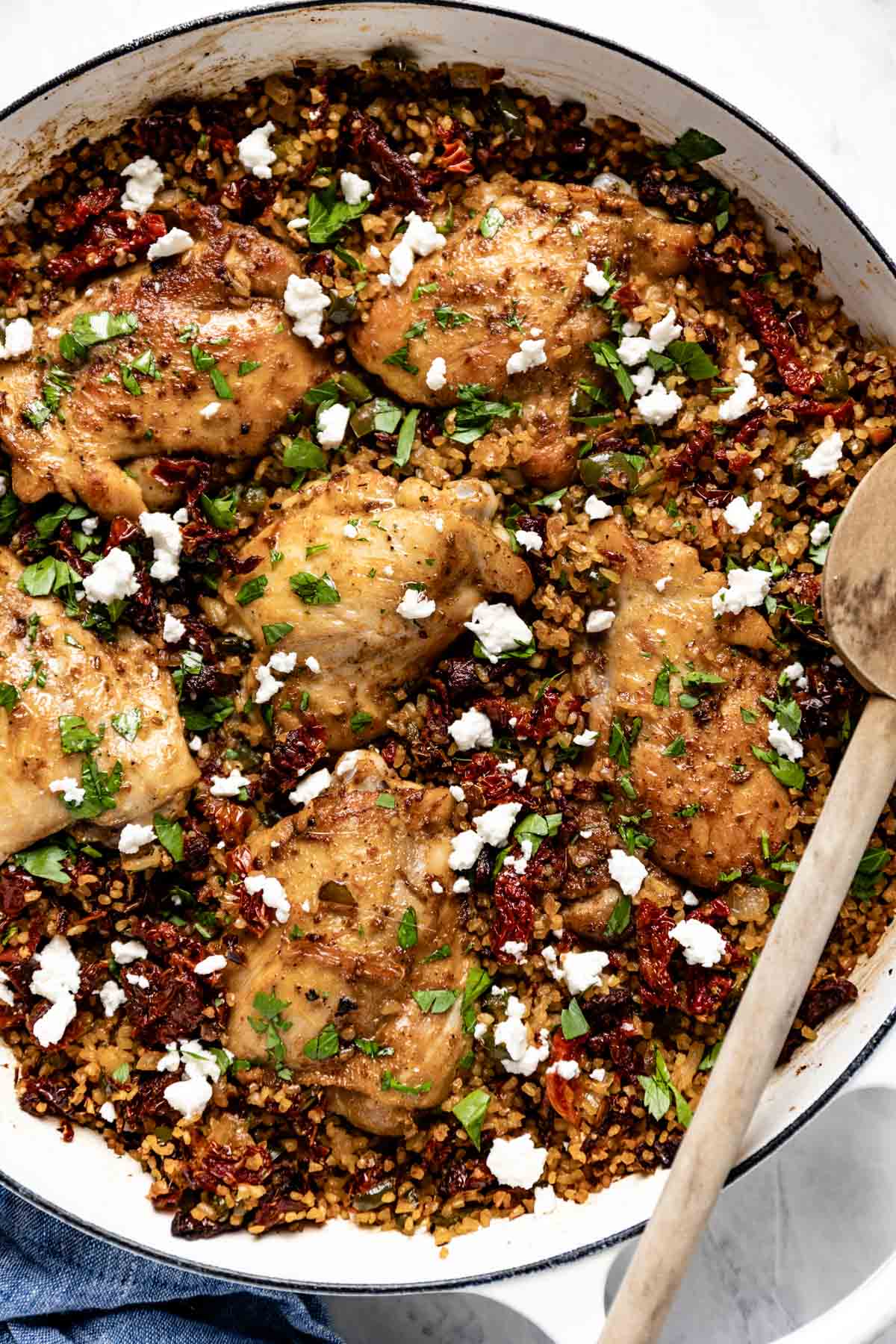 A chicken and grain dish topped with feta cheese from the top view.