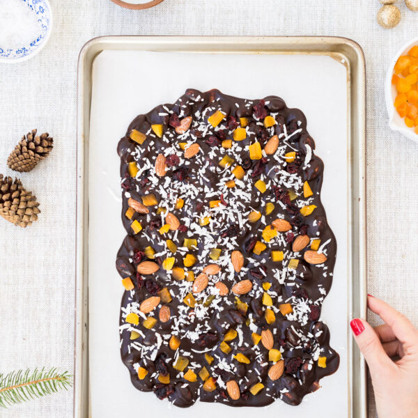Chocolate Almond Bark Recipe Coconut oil based and maple-sweetened Chocolate Almond Bark recipe held by a woman