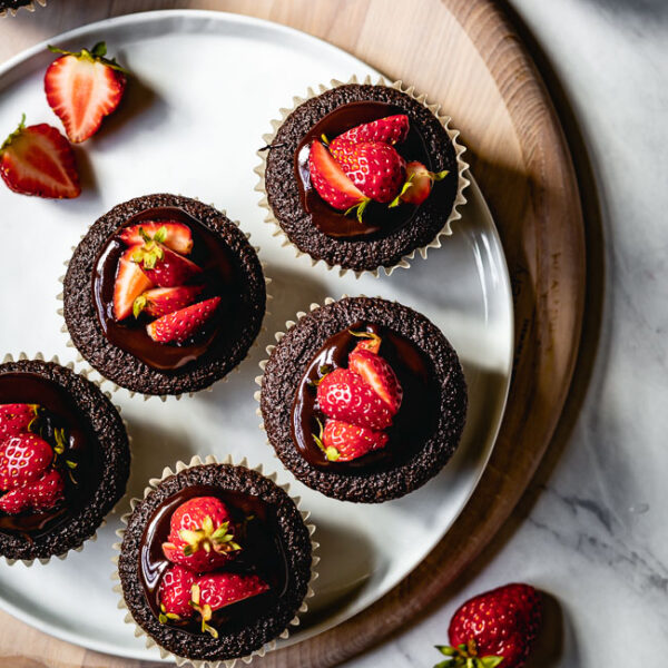 Chocolate muffins with strawberries on top