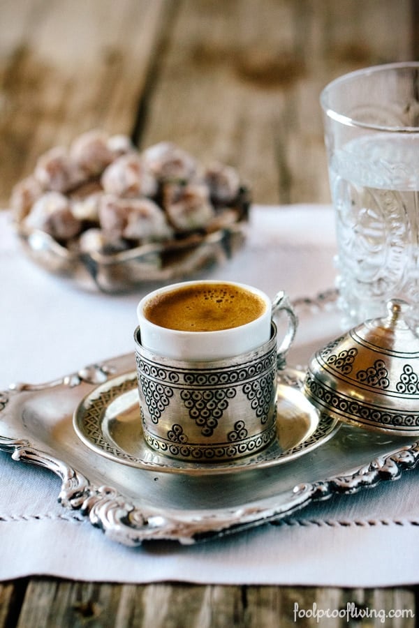 A cup of freshly cooked turkish coffee is photographed from the front view.