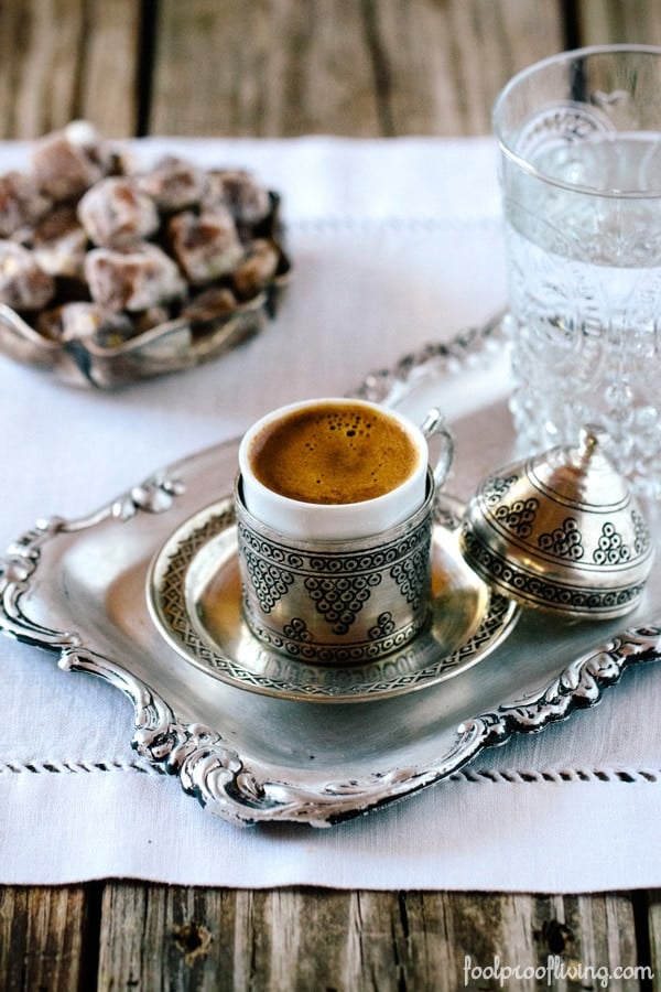 A cup of Turkish Coffee is photographed from the front view.