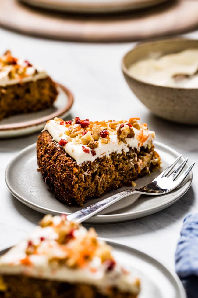 A slice Almond Flour Carrot Cake is photographed from the front view.