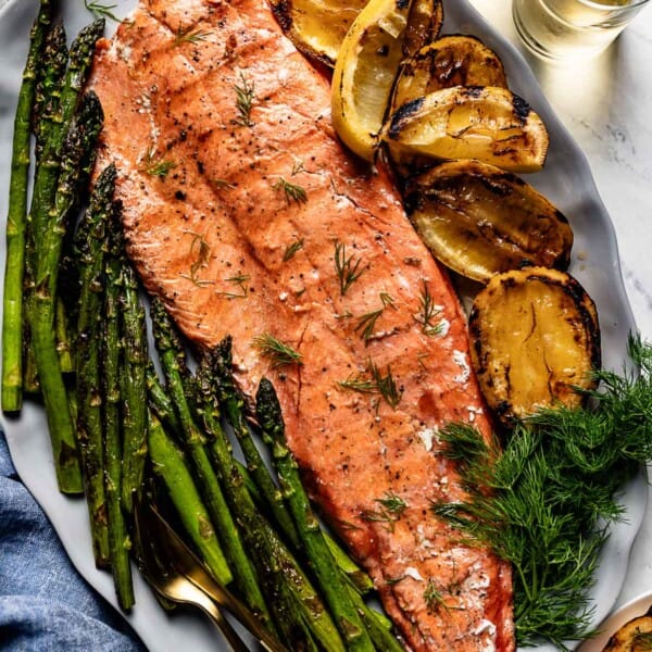 Grilled Sockeye salmon with asparagus and grilled lemon on the side.