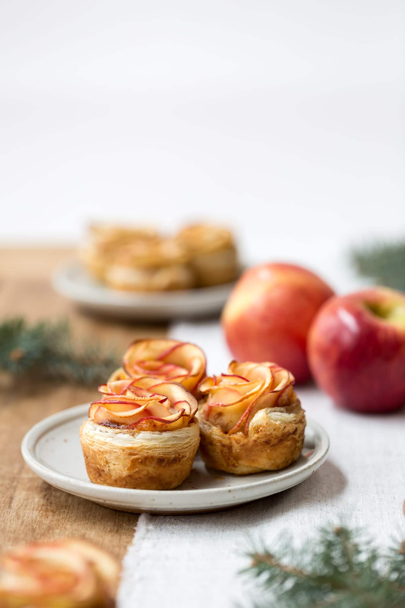 Puff Pastry Apple Roses - Showcasing the leaves of freshly baked apple roses served on small plates.