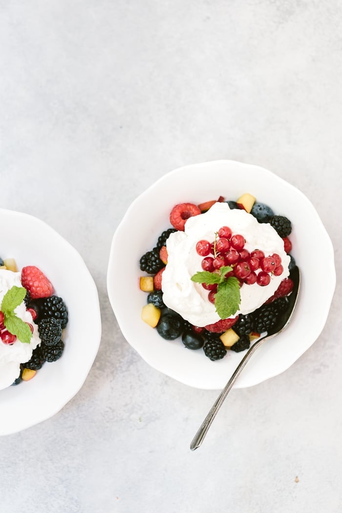 Homemade Maple Whipped Cream Recipe placed in two bowls with fruit