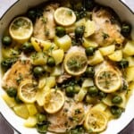 Mediterranean lemon chicken bake in a skillet from the top view.