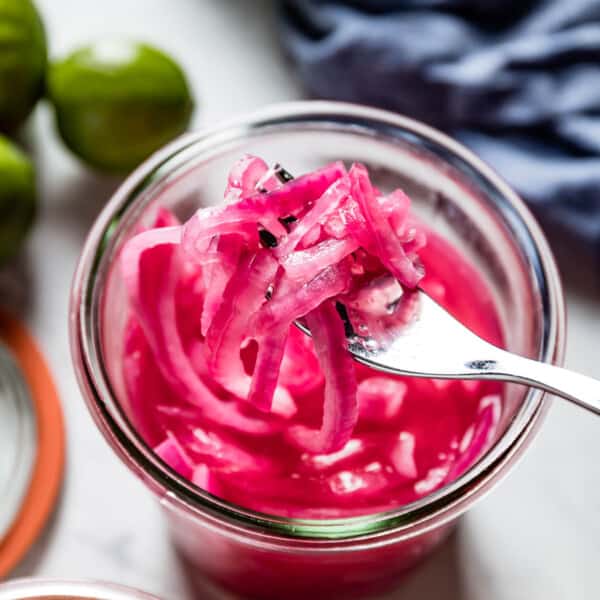 Mexican pickled onions in a jar with a fork from top view