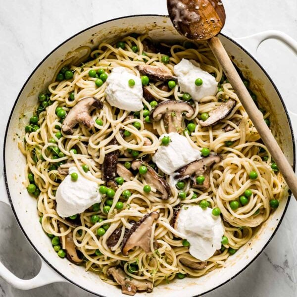 Pasta with Mushrooms and Peas in a large skillet garnished with ricotta cheese