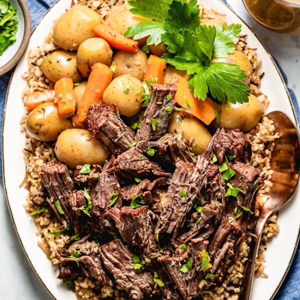 Pressure cooker pot roast on a plate with potatoes
