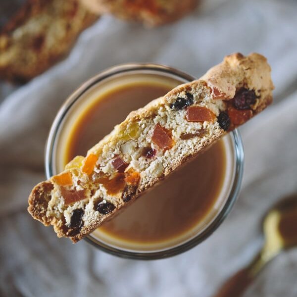 A slice of Caribbean Biscotti resting on a cup of coffee
