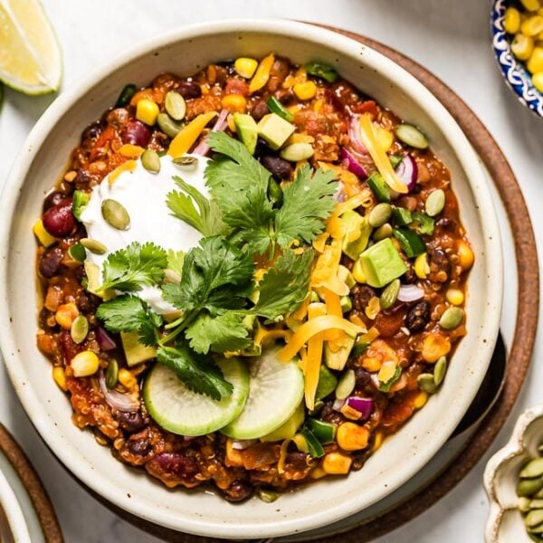 Vegetarian Quinoa Chili Recipe served in a bowl and topped off with various chili toppings