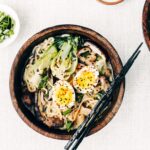 Recipe image for Weeknight Vegetarian Ramen Bowl with Shiitake Mushrooms and Bok Choy - Two ramen bowls photographed from the top view.