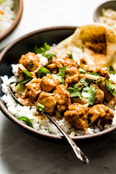 Slow Cooker Butter Chicken placed in a bowl over basmati rice