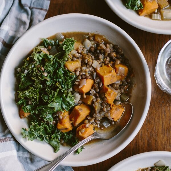 A bowl of Slow Cooker Butternut Squash Lentil Stew Recipe with a spoon on the side