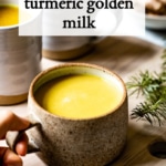 turmeric golden milk placed on a board by a person