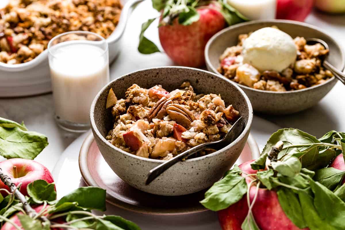 Vegan apple crumble in a bowl with a spoon